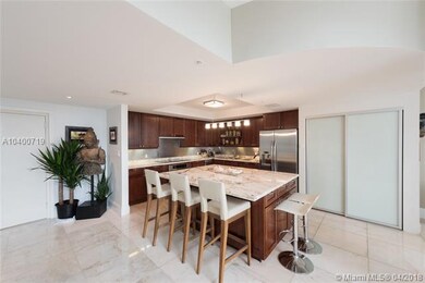 Open kitchen and island. Marble and wood.