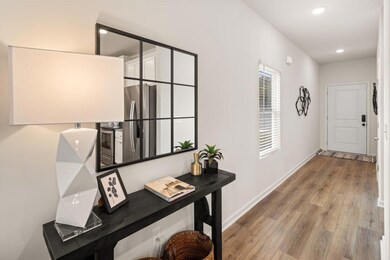 Corridor with wood finished floors and recessed lighting