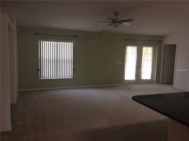 FAMILY ROOM W/BUILT IN AND FRENCH DOORS TO SCREEN 