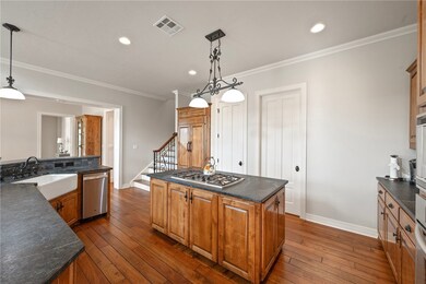 Kitchen featuring stainless steel appliances, dark