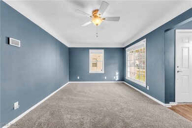 Spare room featuring ceiling fan and carpet floors
