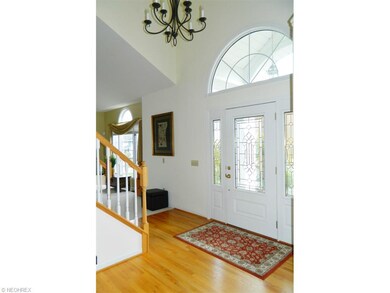Gleaming hardwood floors in the two story foyer