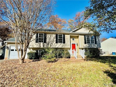 Raised ranch with a front yard and a garage