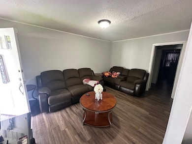 Living area featuring wood finished floors and a t