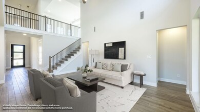 Living room with a high ceiling, wood finished fl
