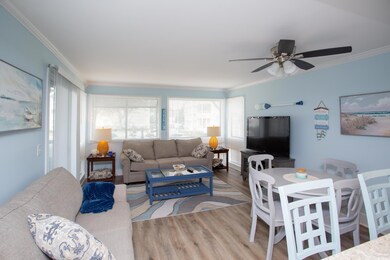 Living room featuring ceiling fan, hardwood / wood