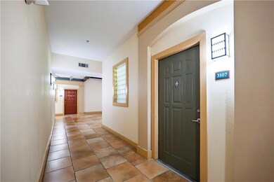 Hallway with baseboards and light tile patterned flooring