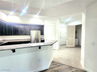 Kitchen featuring freestanding refrigerator, a bre