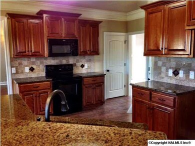 THE KITCHEN OFFERS A TILE BACKSPLASH PLUS EAT IN BAR!!