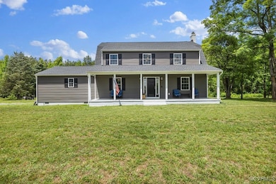View of front facade with a front lawn, a porch, a