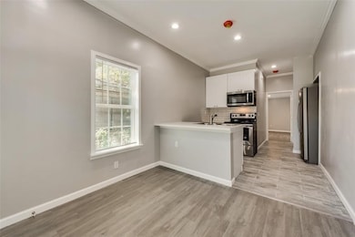 Open concept kitchen / living room area with entra