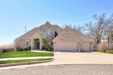 View of front of property with fence, driveway, a front lawn, a garage, and brick siding