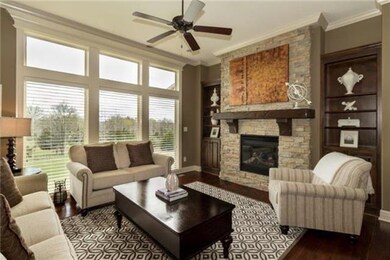 A floor to ceiling stone fireplace with warm built