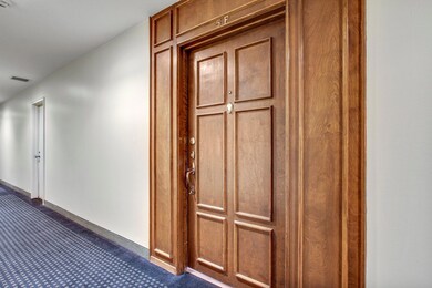 Hallway featuring baseboards and dark colored car