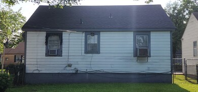 Rear view of property featuring a shingled roof