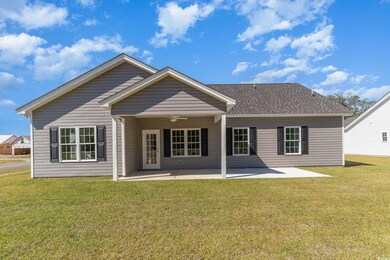 Rear view of property featuring a yard and a patio