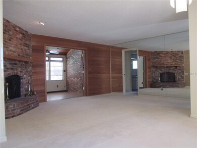 Large open great room features brick wood burning 
