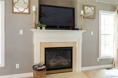 Gas log fireplace and beautiful mantle in living r