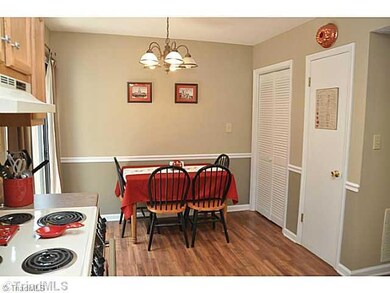 Dining Room. Sweet kitchen also features tasteful laminate flooring and plenty of room for your table and chairs so that you can grab a bite of breakfast before heading out to jog around the lake!
