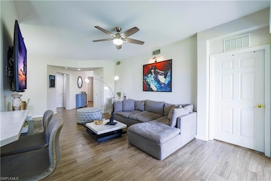 Living room featuring a ceiling fan and wood finished floors