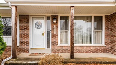 Covered front porch, storm door and large picture window.