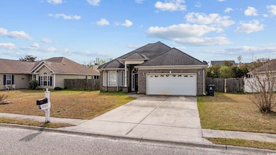 View of front of home with a garage, brick siding,