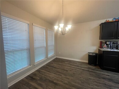 Unfurnished dining area featuring a chandelier, da