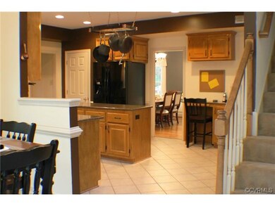 Open kitchen with rear staircase.