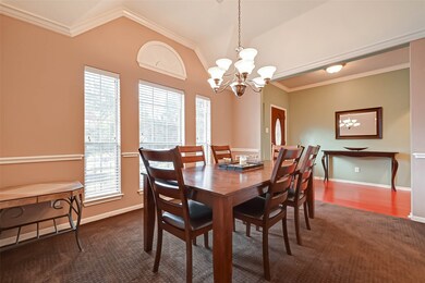 Formal dining has high arched ceilings with crown