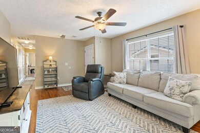 Spacious, natural light-filled living room.