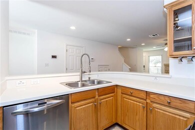 Kitchen featuring stainless steel dishwasher, lig
