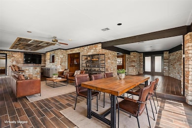 Dining area featuring ceiling fan, visible vents,