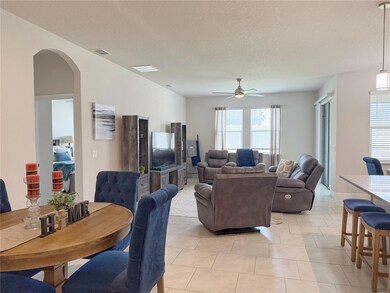 Living room and Dining room from front entry hallway, ceramic tile on offset, extra tall ceilings and doors, open floor plan with split bedroom floorplan