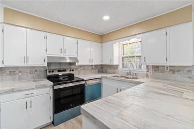 Kitchen featuring dishwashing machine, stainless s