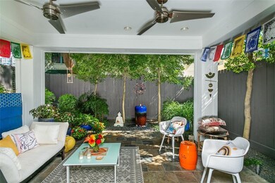 Lush landscaping in the backyard and a covered bac