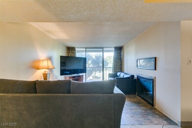 Living area featuring a glass covered fireplace, a