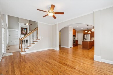 Unfurnished living room with baseboards, arched wa