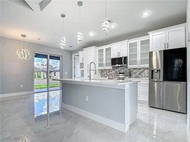 Kitchen with stainless steel appliances, light mar
