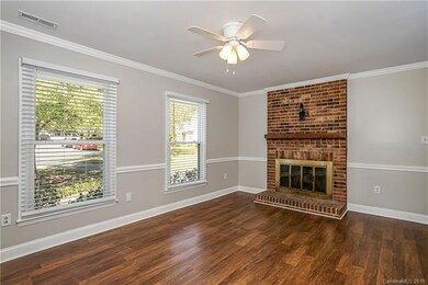 Family room features a wood burning fireplace.