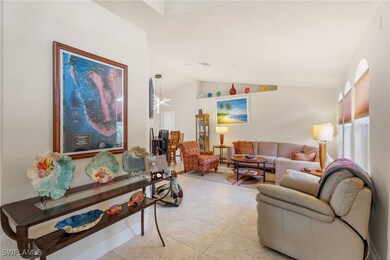 Tiled living room featuring vaulted ceiling