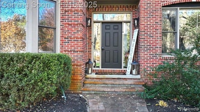 View of exterior entry featuring brick siding