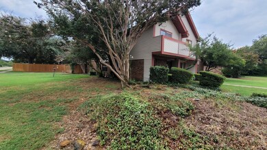 View of home's exterior with a balcony and a yard
