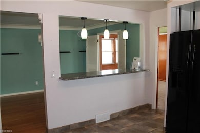 Open concept to dining room with granite counter-t