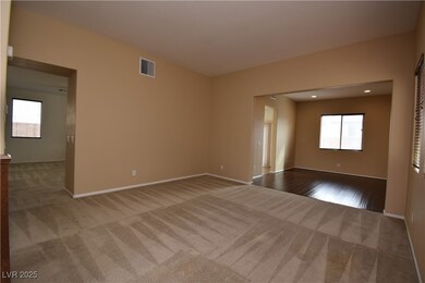 Empty room with light colored carpet, a healthy amount of sunlight, and visible vents