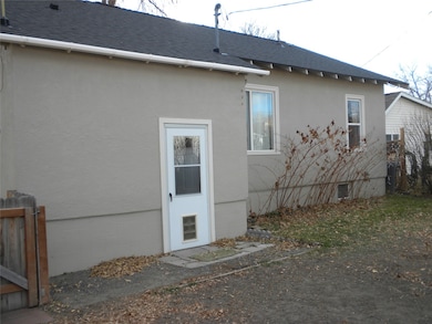View of property exterior with a shingled roof and stucco siding