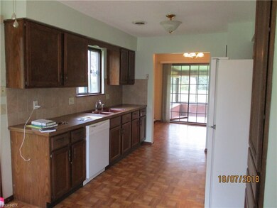 A bright kitchen with dishwasher, range, refrigera