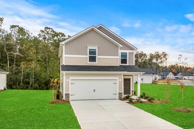 View of front of house with a garage and a front y