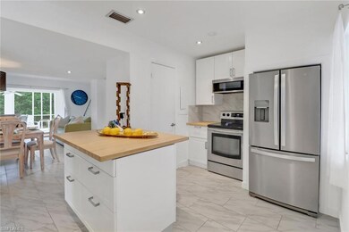 Kitchen featuring white cabinetry, light tile patt