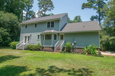 Rear view of property featuring a lawn