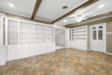 Spare room featuring built in shelves, beamed ceil